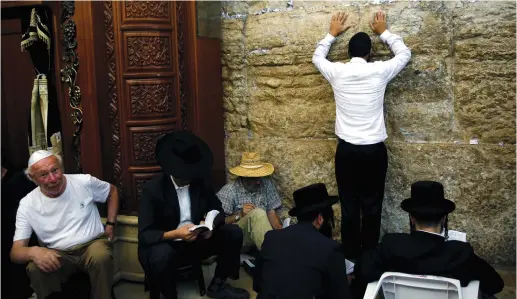  ??  ?? MEN PRAY next to the Western Wall.