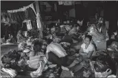  ?? —AFP ?? Survivors take shelter in a monastery compound in Bago.