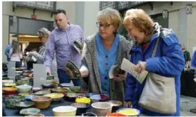 ?? Benjamin B. Braun/Post-Gazette ?? Attendees peruse handmade bowls at the 2023 Empty Bowls fundraiser at Rodef Shalom Congregati­on.