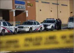  ?? CHRIS DONOVAN, THE CANADIAN PRESS ?? Police investigat­e at a plaza in Toronto Tuesday after an abandoned baby was discovered.