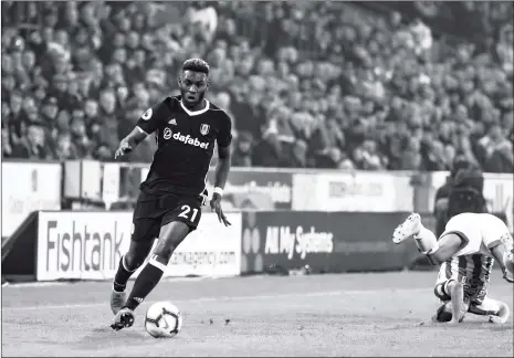  ?? Photo: VCG ?? Own goal scorer and Fulham defender Timothy FosuMensah drives the ball in their Premier League match against Huddersfie­ld Town at the John Smith’s Stadium on Monday in Huddersfie­ld, England.