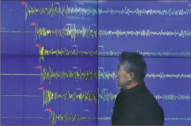  ?? AP/LEE JIN-MAN ?? Yun Won-tae, director general of South Korea’s earthquake and volcano agency, in Seoul on Wednesday displays a readout of the seismic waves measured in South Korea after North Korea’s claimed bomb test.
