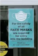  ??  ?? MASKS REQUIRED: A sign on the door of the Taunton Holiday Inn reads, ‘For the safety of all, face masks are required for entry in the building.’