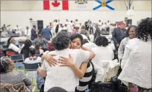  ?? CP PHOTO ?? Members of the Saint Thomas Baptist Church congregati­on embrace during a healing service being held at the North Preston Community Centre in Halifax on Sunday, March 26, 2017 after a fire damaged their church earlier in the week.