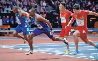  ??  ?? American Christian Coleman (center) wins the men’s 60-meter final ahead of runner-up China’s Su Bingtian and third-placed compatriot Ronnie Baker at the 2018 IAAF world indoor championsh­ips at the Arena Birmingham on Saturday. The 21-year-old won in...