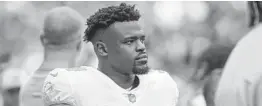  ?? GARY MCCULLOUGH/ AP ?? Dolphins running back Malcolm Brown walks the sideline before a game against the Jaguars at Tottenham Hotspur Stadium in London on Oct. 17.