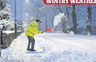  ??  ?? Clearing a path One Perth resident tries to shift the snow from the pavement