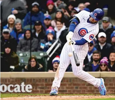  ?? QUINN HARRIS/GETTY IMAGES ?? Fans watch as Ian Happ hits a two-run double in the seventh inning Thursday.