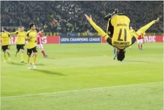  ??  ?? DORTMUND: Dortmund's Pierre-Emerick Aubameyang celebrates after scoring his side's fourth goal during the Champions League round of 16, second leg, soccer match between Borussia Dortmund and Benfica in Dortmund, Germany, yesterday. — AP