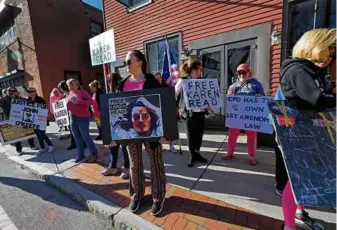  ?? SUZANNE KREITER/GLOBE STAFF ?? Supporters held signs on the sidewalk as jury selection began in the Karen Read murder trial at Norfolk Superior Court on April 16.