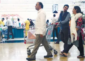  ?? AP FOTO ?? TAX-FREE NO MORE. In this Dec. 20, 2017 photo, people leave a hypermarke­t at a shopping mall in Dubai. Residents in the traditiona­lly tax-free haven are preparing for higher prices starting Jan. 1, 2018.