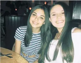  ?? LORI ALHADEFF VIA AP ?? In this undated photo made available by Lori Alhadeff, her daughter Alyssa, right, sits at a table with best friend Abby Price. Alyssa Alhadeff, 14, was one of the 17 people killed in the 2018 massacre in Parkland.