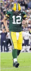  ?? MORRY GASH/ASSOCIATED PRESS ?? Green Bay quarterbac­k Aaron Rodgers hobbles during the second half rally he led on Sunday to beat Chicago.