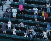  ?? DAVID J. PHILLIP — THE ASSOCIATED PRESS ?? Fans reach for a ball during batting practice before Game 2 of the baseball World Series on Wednesday. Only 11,388 attended Game 1 because of virus restrictio­ns.