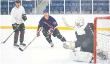  ?? JIM IVEY ?? West Hants’ CAO Mark Phillips got in on the action during an alumni hockey game March 12 in Windsor.