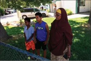  ?? AP/REBECCA BOONE ?? Fathi Mahamoud, 11, (left), Esrom Habte, 12, and Thado Aip on Sunday describe the attack Saturday night that left nine residents of their Boise, Idaho, apartment complex with stabbing injuries.