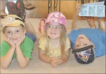  ?? SALLY COLE/THE GUARDIAN ?? Clare Kasycz and her friends, Bentley Lubrick, left, and Riley Lubrick, take in a performanc­e of “The Magical Maple Leaf Mystery” at the Carriage House.