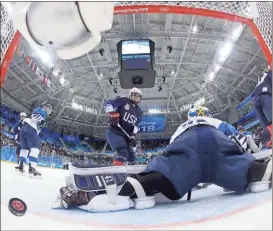  ?? Matt Slocum / Pool photo via AP ?? American Jocelyne Lamoureux-Davidson scores past Finnish goalie Noora Raty (41) during the second period of the women’s hockey semifinal round in Gangneung, South Korea.