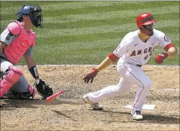  ?? Wally Skalij Los Angeles Times ?? THE ANGELS’ Jared Walsh runs out of the batter’s box after connecting for a two-run, ground-rule double in the third inning. Dodgers catcher Will Smith is at left. The Angels won 2-1 to take two of three in the series.