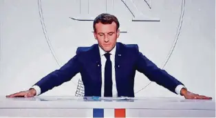  ??  ?? Präsident Macron gestern am TV bei der Verkündung harter Corona-massnahmen. REUTERS