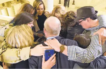  ?? MARC LEVY/AP FILE PHOTO ?? Survivors of child sexual abuse hug in the Pennsylvan­ia Capitol while awaiting legislatio­n in October to respond to a landmark state grand jury report on child sexual abuse in the Roman Catholic Church.