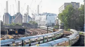  ?? — Reuters ?? London project: Trains passing near constructi­on work taking place around Battersea Power Station in London. The project was launched about five years back.