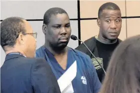  ?? MARC FREEMAN/STAFF ?? Tilus Lebrun, center, stands in a Palm Beach County courtroom Monday as he was found not guilty by reason of insanity in the March 13, 2014 stabbing death of Dimitrios Karaloukas.