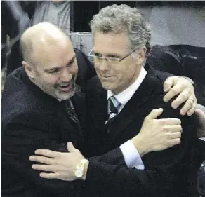  ??  ?? Coaches Charlie Huddy and Craig MacTavish celebrate Edmonton’s Game 6 victory over the Detroit Red Wings in the first round of the 2006 playoffs.