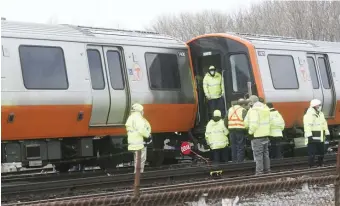  ?? NicoLaus czarnecki / heraLD staff fiLe ?? STILL LOOKING FOR ANSWERS: MBTA crews work at the scene of an Orange Line train derailment outside the Wellington Station in Medford on March 16. Shuttle service between Oak Grove, seen at left on March 25, and Sullivan Square stations due to the derailment ended Monday.