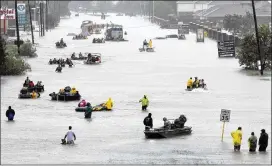  ?? DAVID J. PHILLIP / AP 2017 ?? Rescue boats float on a flooded street as people are evacuated from rising floodwater­s brought on by Tropical Storm Harvey in Houston, Aug. 28, 2017.