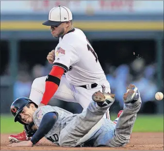  ?? [PAUL BEATY/THE ASSOCIATED PRESS] ?? The Indians’ Bradley Zimmer slides safely into second base on a sacrifice by Francisco Lindor, as White Sox second baseman Yoan Moncada applies a late tag in the first inning.