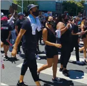  ?? WES GOLDBERG — STAFF ?? The Warriors’ Stephen Curry and his wife Ayesha were part of a protest march around Lake Merritt on Wednesday.