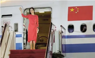  ?? /Jin Liwang/Xinhua via Reuters ?? Back home: Huawei Technologi­es CFO Meng Wanzhou waves as she steps out of a charter plane at Shenzhen Baoan Internatio­nal Airport in Shenzhen, Guangdong Province, China on September 25 2021.