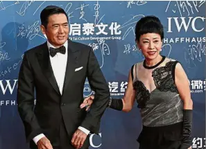  ?? — EPA ?? Loving couple: Chow was in high spirits at the 63rd birthday party thrown by Tan, even dancing with veteran actor Tse.