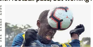  ?? Another ball game: Usain Bolt heading the ball as he trains with A-League club Central Coast Mariners in Gosford yesterday. — AFP ??