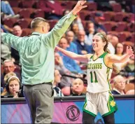  ?? David G. Whitham / For Hearst Connecticu­t Media ?? Holy Cross’ Mya Zaccagnini is greeted by coach Frank Lombardo after scoring her career 1,000th point during the CIAC Class M final against Bacon Academy on Sunday at Mohegan Sun Arena.