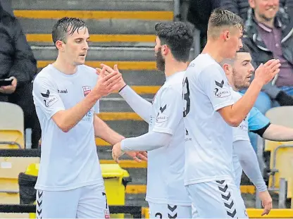  ?? Picture: Phoenix Photograph­y. ?? Graham Webster, left, is congratula­ted after scoring Montrose’s goal.