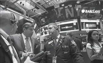  ?? -AP ?? Traders work on the floor of New York Stock Exchange.