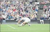  ?? ALASTAIR GRANT — THE ASSOCIATED PRESS ?? Novak Djokovic slips on the grass during his men’s singles second-round match against Kevin Anderson on day three of Wimbledon on Wednesday in London.