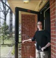  ?? JOHN MINCHILLO — THE ASSOCIATED PRESS FILE ?? Mindy Nagel poses for a photograph at the threshold of her home in Cincinnati.