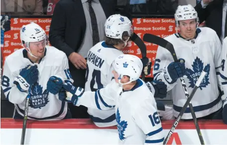  ?? CP PHOTO ?? Mitch Marner of the Toronto Maple Leafs celebrates with teammates after scoring against the Montreal Canadiens in the third period of an NHL preseason game in Montreal on Wednesday night.