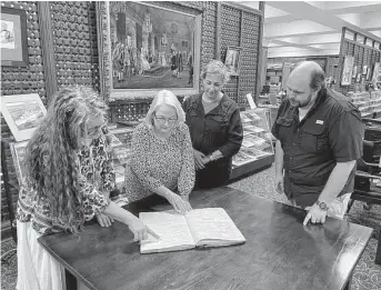  ?? Courtesy of Sam Houston State University ?? Ellen Collins, from left, Darin Bailey and Sara Forlano from the Montgomery County Clerk’s Office and Trent Shotwell of SHSU look at the recovered county death records from 1937 to 1949.
