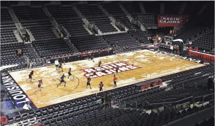  ?? LEE CELANO/THE ADVERTISER ?? The Louisiana-Lafayette women’s basketball team practices on the Cajundome court that featured a silhouette of a cypress swamp on Lake Martin.