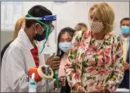  ?? (AP/Atlanta Journal-Constituti­on/Alyssa Pointer) ?? Education Secretary Betsy DeVos talks with sophomore Yugeshwar Muralidhar in a biotech classroom Tuesday at Forsyth Central High School in Cumming, Ga.