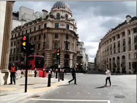  ?? (AP/Alastair Grant) ?? A street at Bank junction in London is quiet Tuesday. When the pandemic struck, about 540,000 workers vacated London’s financial hub almost overnight. A year later, most haven’t returned.