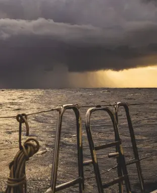  ??  ?? A squall on the horizon that is soon to overtake this yacht. These are common in the tradewinds