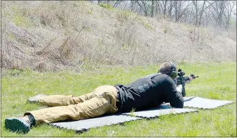  ?? Keith Bryant/The Weekly Vista ?? Cpl. Bobby Warren qualifies with a service rifle. The test requires officers to place 80 percent of their shots from various distances on target. Warren passed with a perfect score.