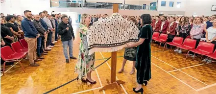 ?? SIMON O’CONNOR/STUFF ?? The korowai that was created in the memory of Sacred Heart Girls College former principal Diane Kawana was handed over to the school on Friday.