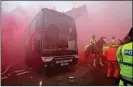  ??  ?? ATTACK: The Manchester City team bus emerges through the smoke