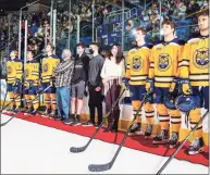  ?? Rob Rasmussen / Quinnipiac Athletics ?? Members of the Quinnipiac men's hockey team and the Torello family stand together at a ceremony on Oct. 23, 2021, to honor Michael Torello, who had died the previous July. Torello was the Bobcats' Team IMPACT teammate.